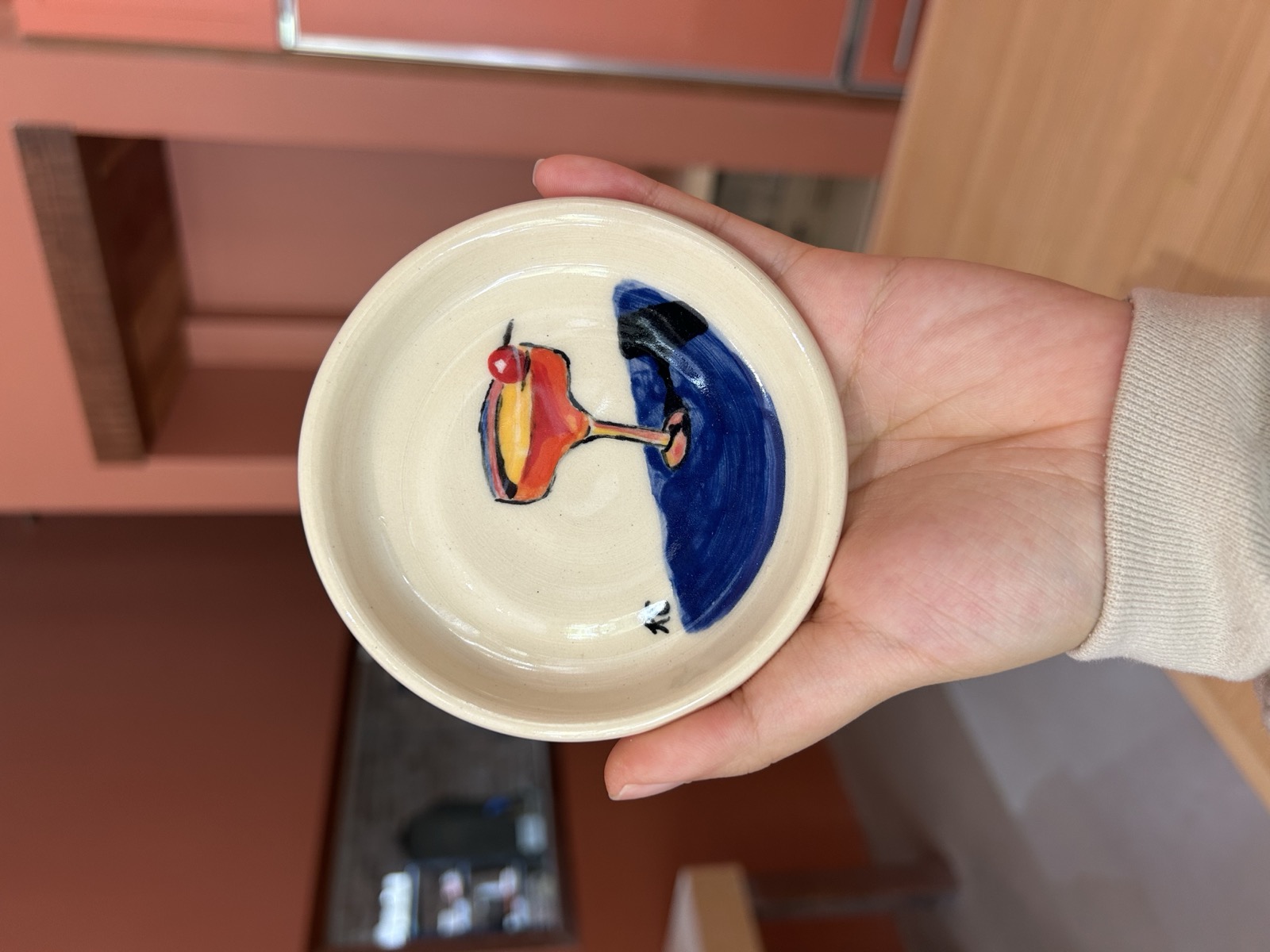 Small dish painted with a cocktail